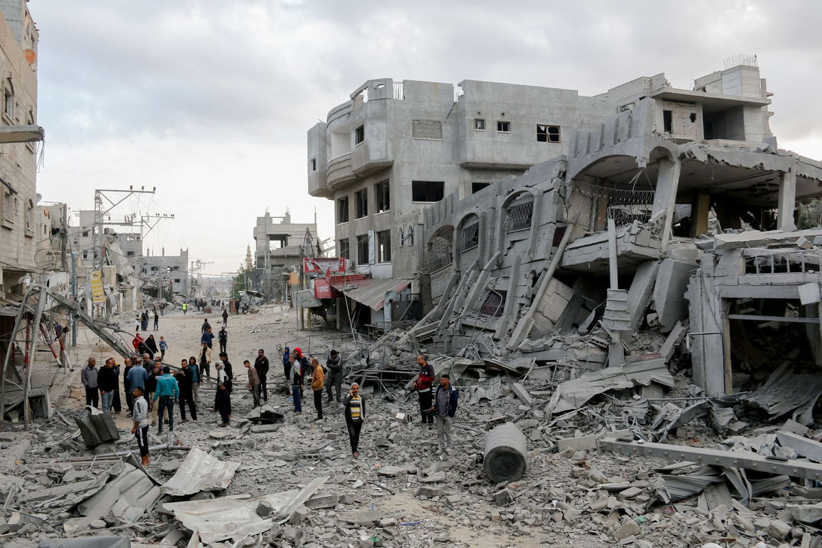 <i>Saeed Jaras/Middle East Images/AFP/Getty Images via CNN Newsource</i><br />Residents walk through streets of rubble in the Al-Zawaida area of the Gaza Strip on November 1.