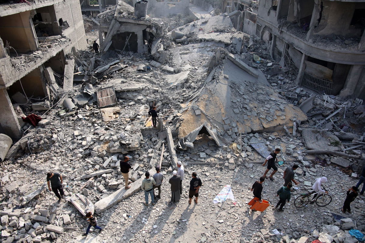 <i>Omar Al-Qattaa/AFP/Getty Images via CNN Newsource</i><br/>Palestinians check the rubble of the Alloush family's house