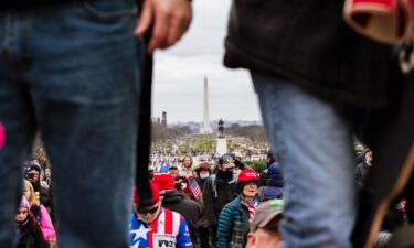 The Washington Monument is seen in the background as pro-Trump protesters break through barriers onto the grounds of the Capitol on January 6