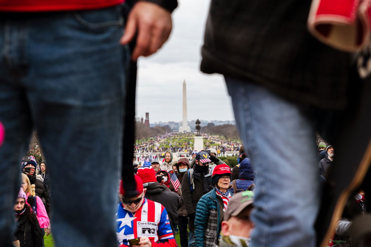 <i>Jon Cherry/Getty Images via CNN Newsource</i><br/>The Washington Monument is seen in the background as pro-Trump protesters break through barriers onto the grounds of the Capitol on January 6