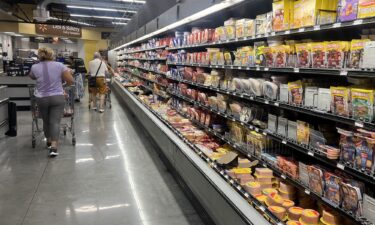 Customers shop in the deli meat aisle of a grocery store on October 17 in Miami.