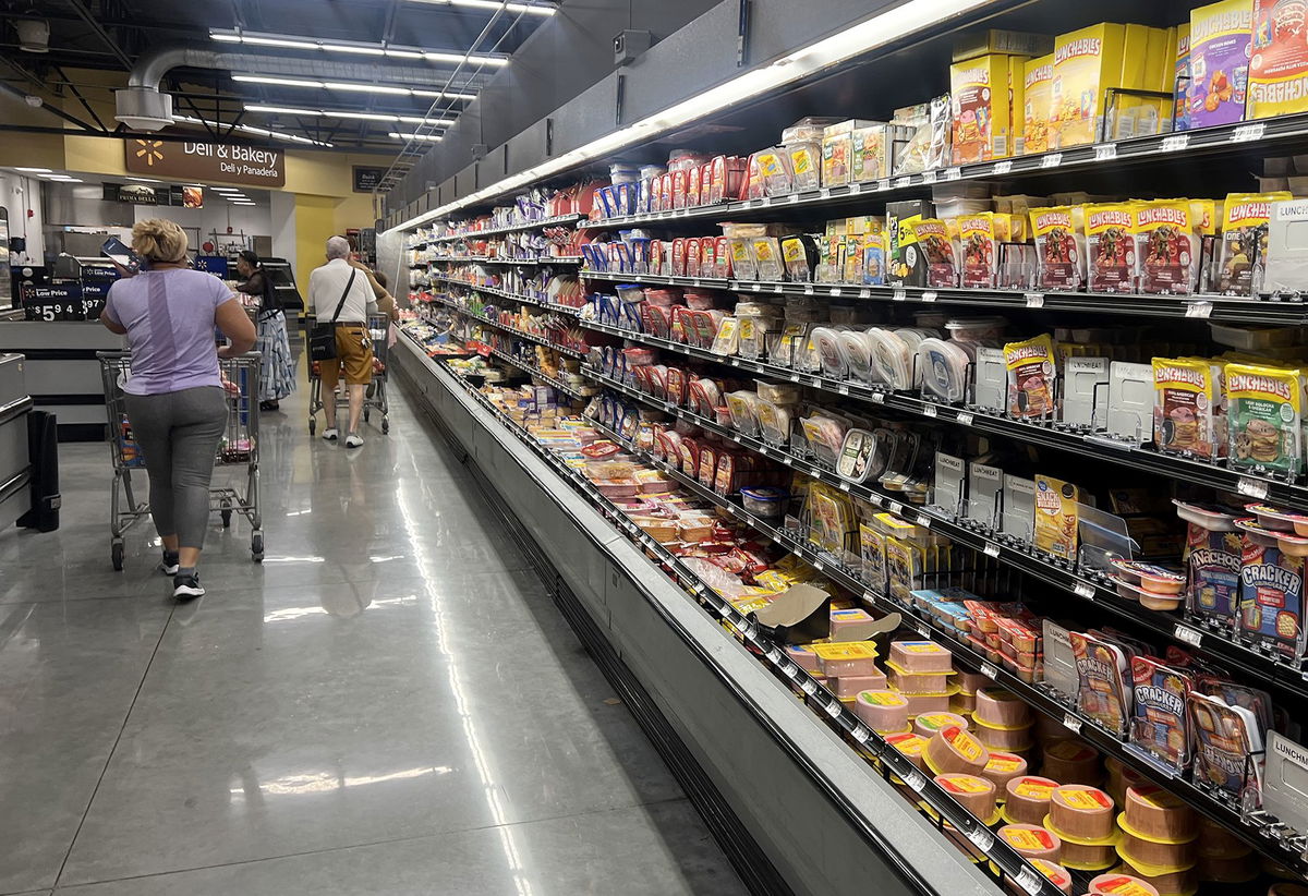 <i>Joe Raedle/Getty Images via CNN Newsource</i><br/>Customers shop in the deli meat aisle of a grocery store on October 17 in Miami.