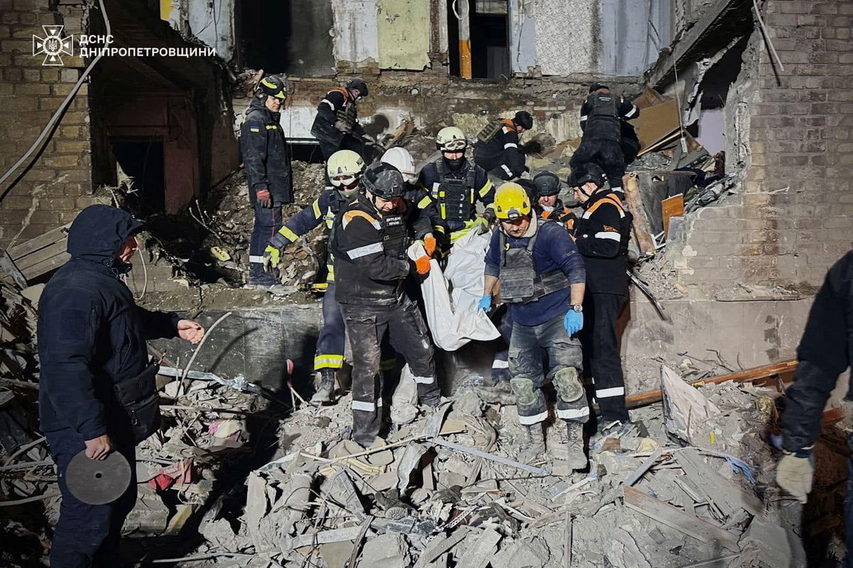 <i>State Emergency Service of Ukraine/REUTERS via CNN Newsource</i><br/>Rescuers carry Olena's body out of the rubble.