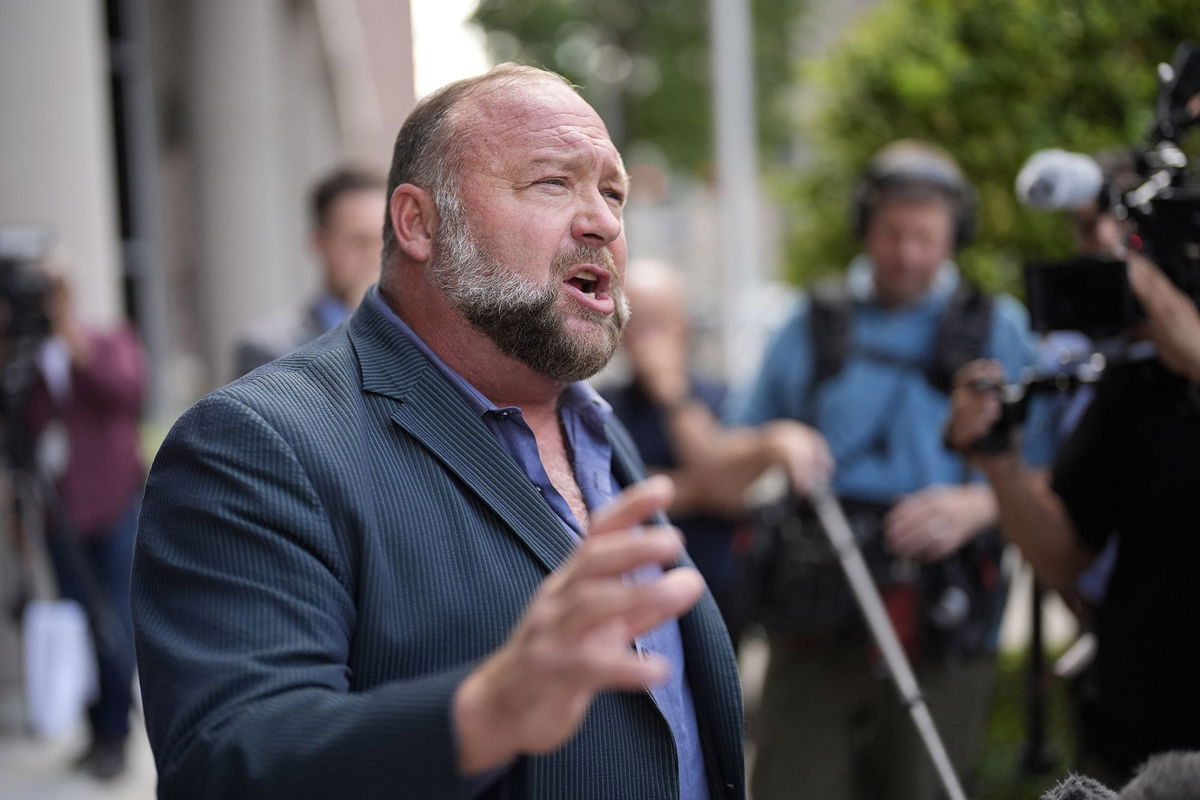 <i>David J. Phillip/AP via CNN Newsource</i><br/>Alex Jones speaks to the media after arriving at the federal courthouse for a hearing in front of a bankruptcy judge