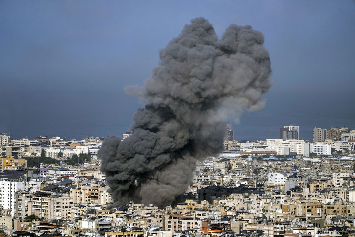 <i>AFP/Getty Images via CNN Newsource</i><br/>A man watches smoke rising behind a destroyed building following an Israeli airstrike on the district of Haret Hreik in Beirut's southern suburbs on November 16