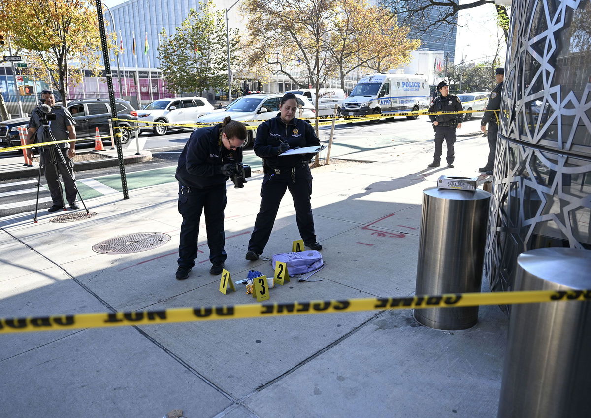 <i>Faith Aktas/Anadolu/Getty Images via CNN Newsource</i><br/>Officers of New York Police Department (NYPD) investigate the site where the suspect of 3 knife attacks that killed 2 was captured and taken into custody at East 46th Street and First Avenue.