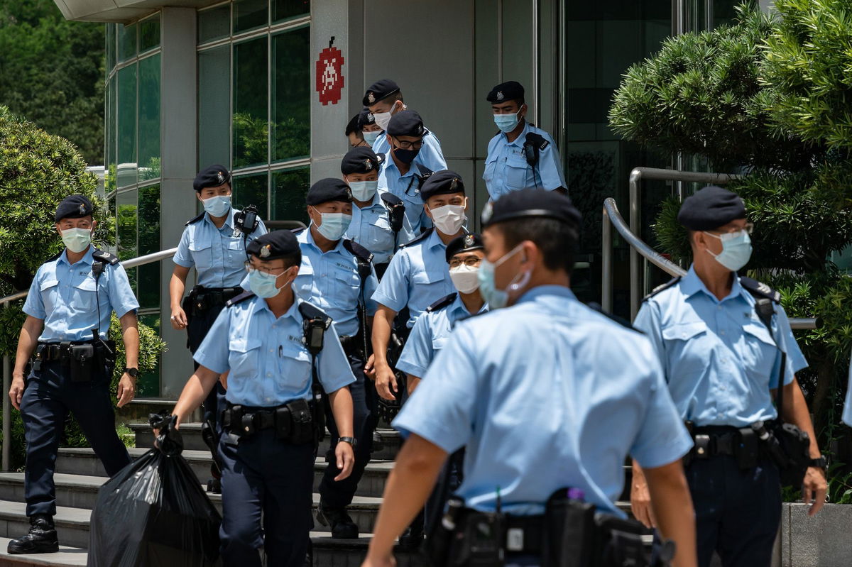 <i>Anthony Kwan/Getty Images via CNN Newsource</i><br/>Police carry evidence they sized from the headquarters of the Apple Daily newspaper on June 17