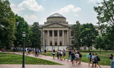 People walk on the campus of the University of North Carolina Chapel Hill on June 29