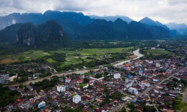 Foreign tourists kayaking and tubing on the Song River in Vang Vieng