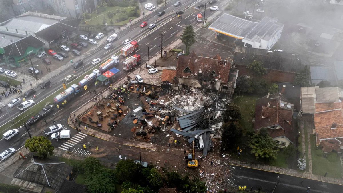 Police carry out an investigation by houses that were hit by a plane in Gramado in Brazil on Sunday. Mateus Bruxel/AP