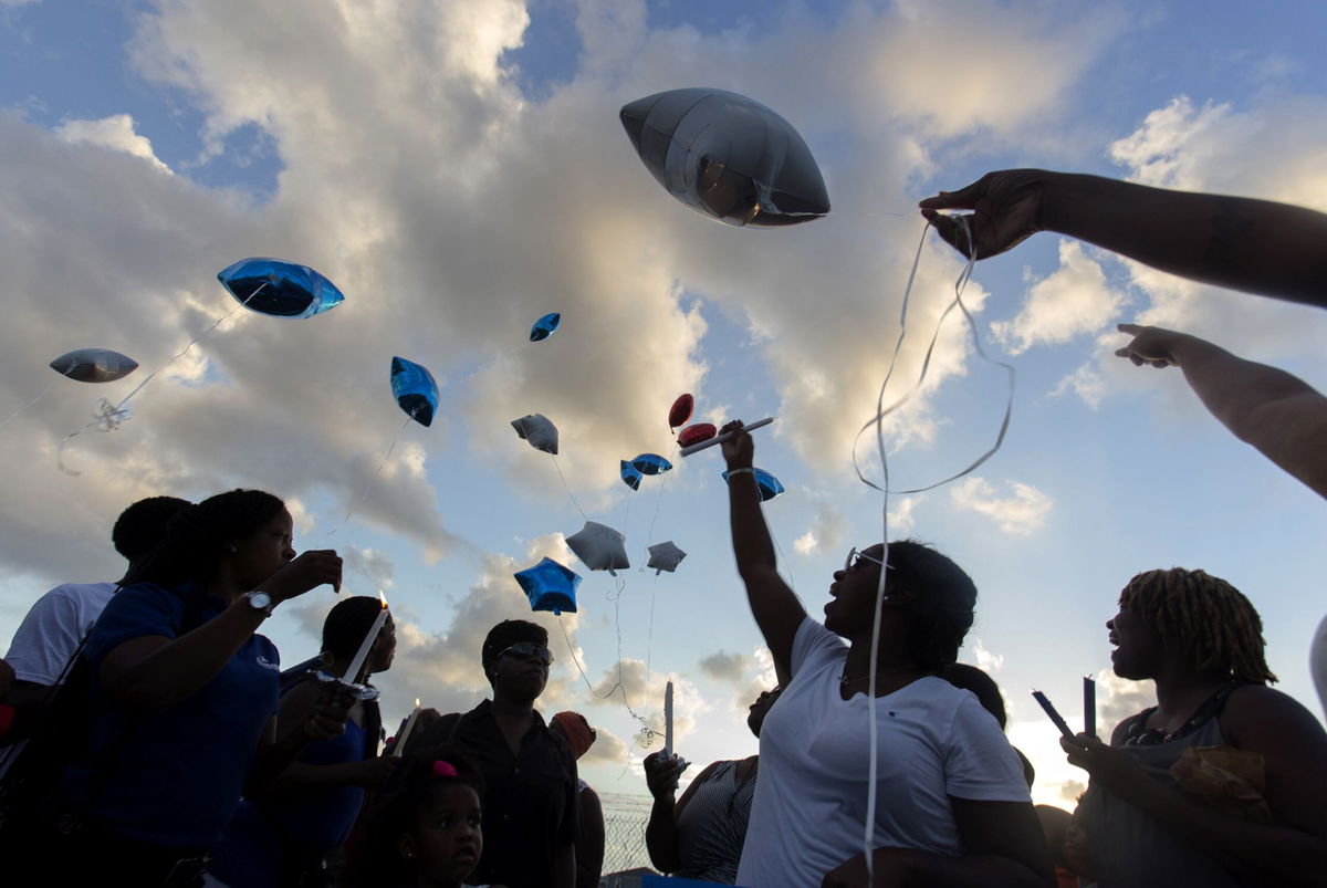 <i>Lee Celano/Reuters via CNN Newsource</i><br />Mourners release balloons at a vigil for New Orleans police officer Daryle Holloway in New Orleans in June 2015. New Orleans