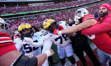 Kaufman carries a flag in the end zone after the game.