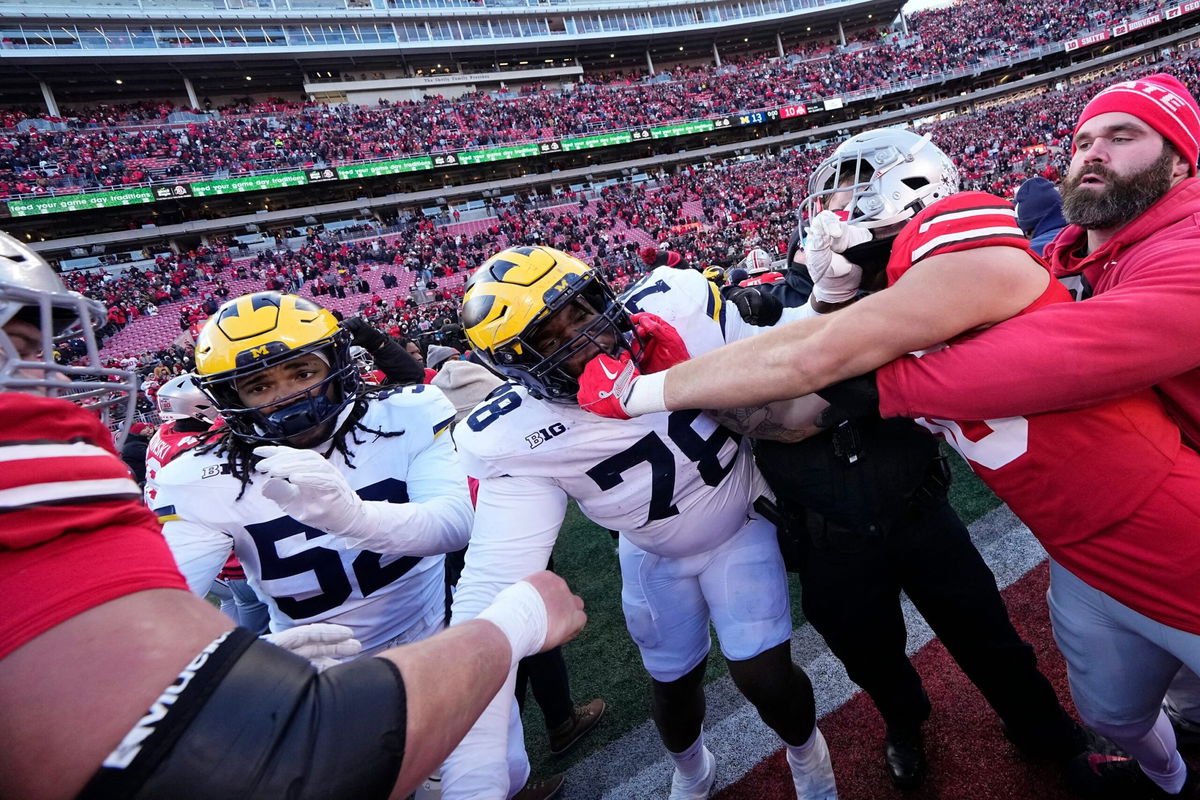 <i>Nicholas Faulkner/Icon Sportswire/AP via CNN Newsource</i><br/>Kaufman carries a flag in the end zone after the game.