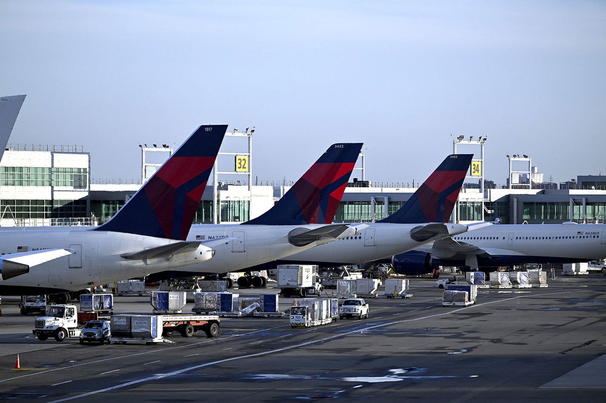 <i>Anthony Behar/Sipa USA/AP via CNN Newsource</i><br/>Delta Air Lines planes stand at their terminal in New York's John F. Kennedy International Airport. The 57-year-old Russian woman who stowed away on a Delta Air Lines flight from New York to Paris last week is set to return to the United States