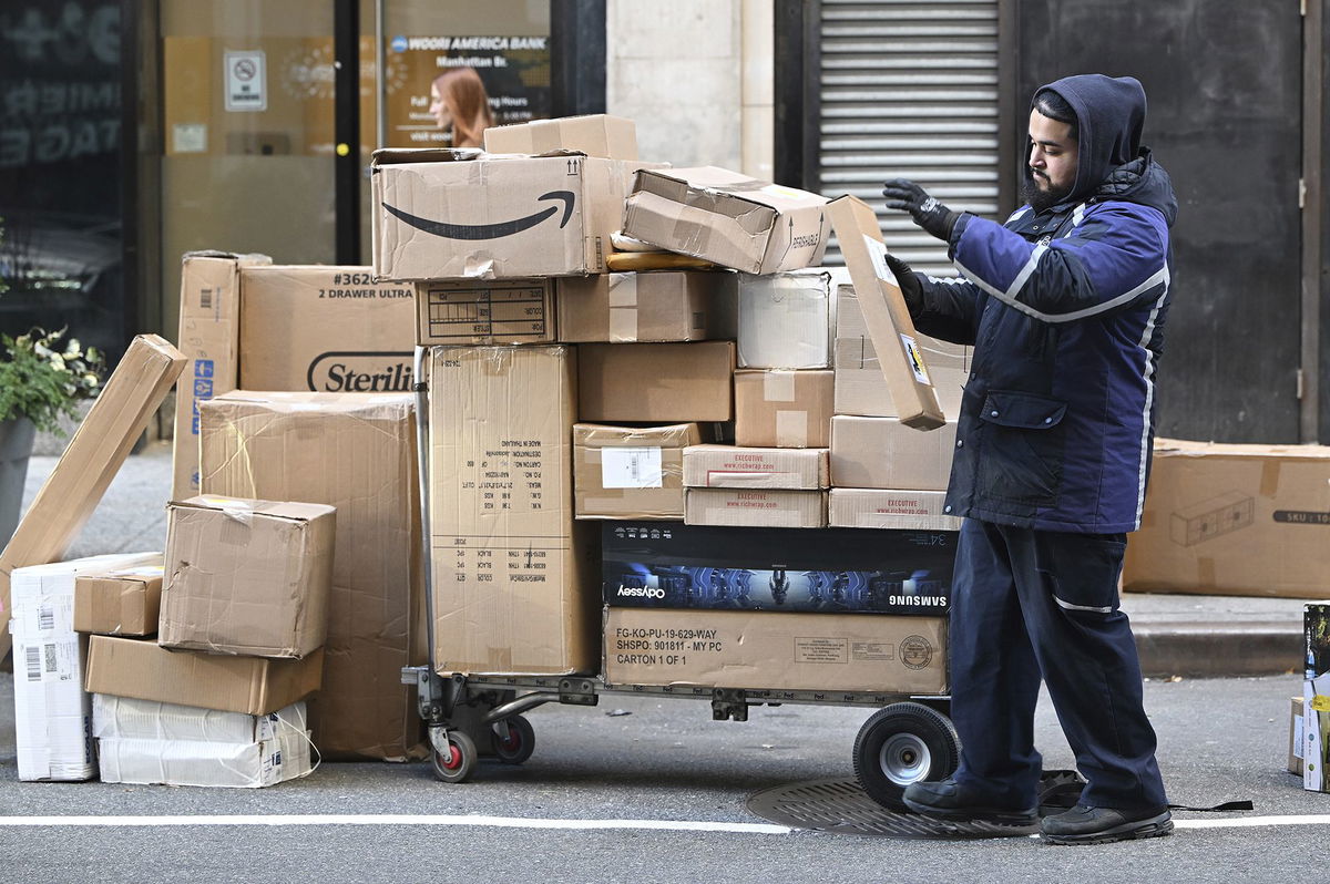 <i>Anthony Behar/Sipa USA/AP via CNN Newsource</i><br/>A Fedex worker sorts through packages set for delivery in Manhattan on December 2. Consumers spent a record $13.3 billion on Cyber Monday