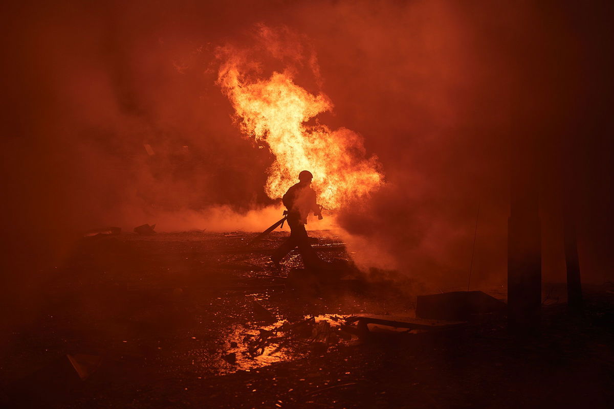 <i>Thomas Peter/Reuters via CNN Newsource</i><br/>A woman reacts at the scene of missile damage.