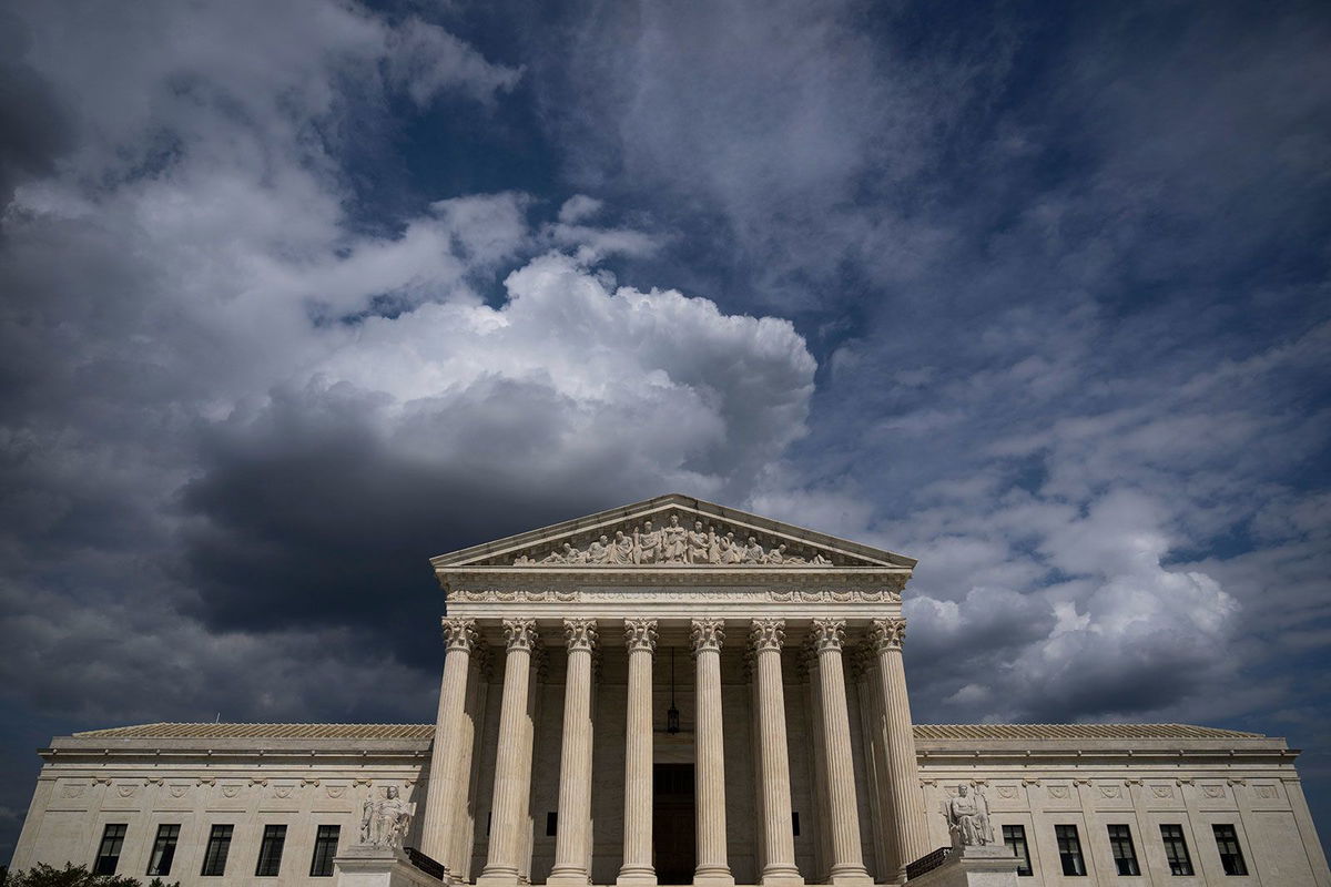 <i>Al Drago/Bloomberg/Getty Images via CNN Newsource</i><br/>Demonstrators in support of gender-affirming treatment make signs outside the US Supreme Court in Washington