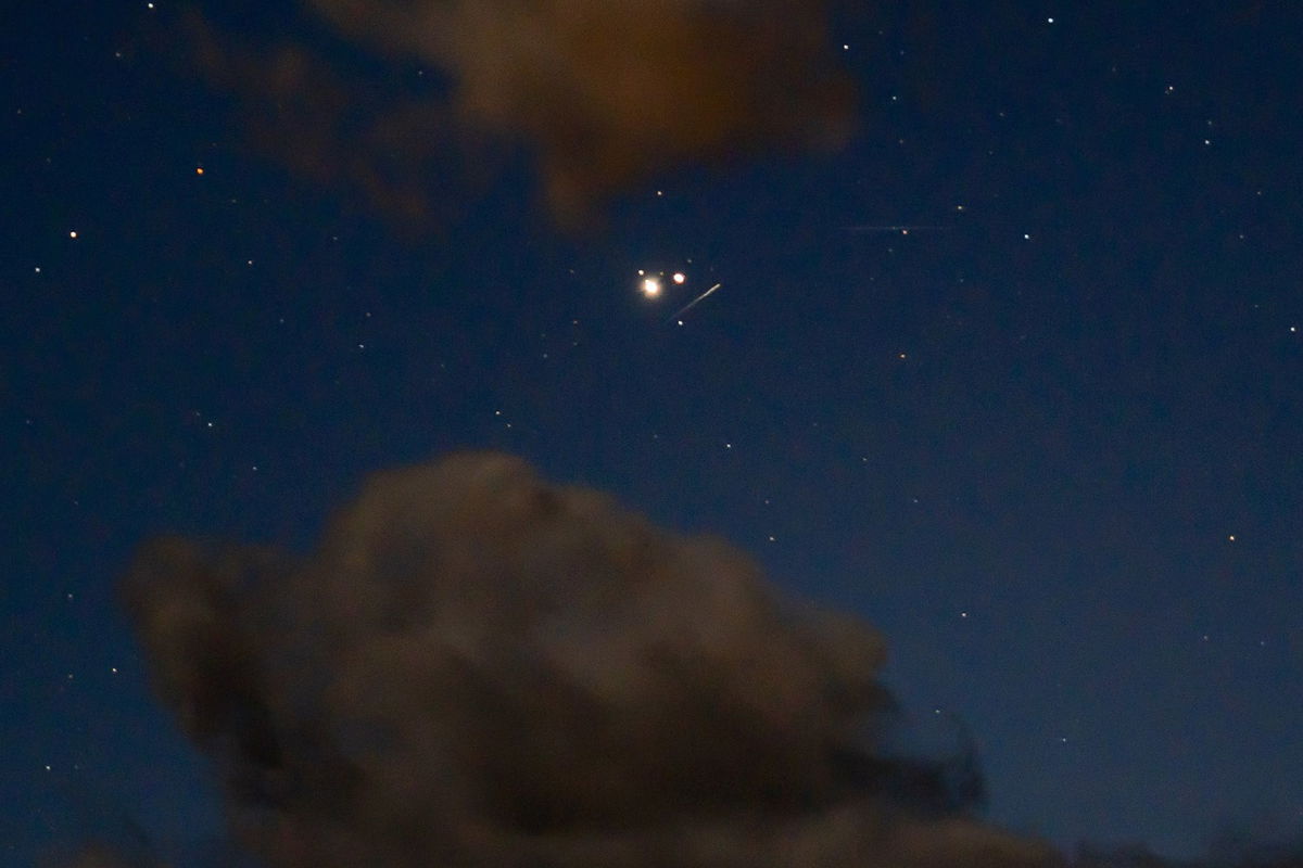 <i>davidhoffmannphotography/iStockphoto/Getty Images via CNN Newsource</i><br/>A meteor from the Ursid meteor shower streaks by Jupiter and Saturn