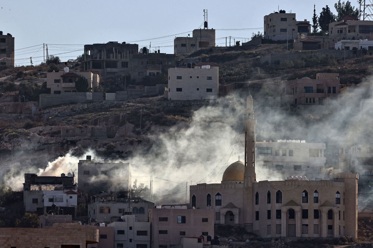 <i>Jaafar Ashtiyeh/AFP/Getty Images via CNN Newsource</i><br/>Palestinian security forces stand guard at a roadblock in Jenin following clashes with militants the day before.