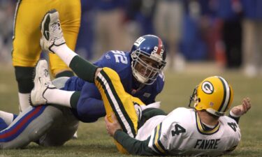 Gastineau congratulates Strahan after breaking the single-season sack record.