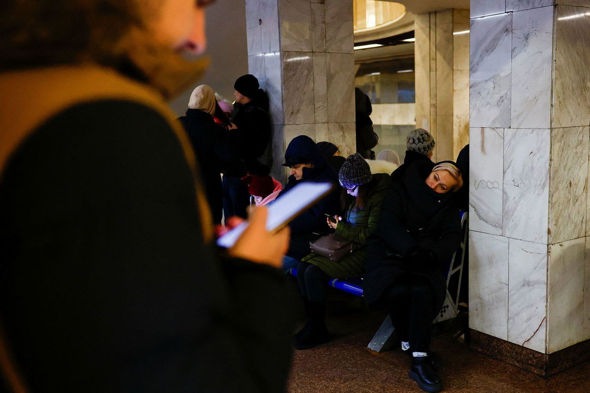 <i>Alina Smutko/Reuters via CNN Newsource</i><br/>People take shelter inside a metro station during a Russian military strike in Kyiv