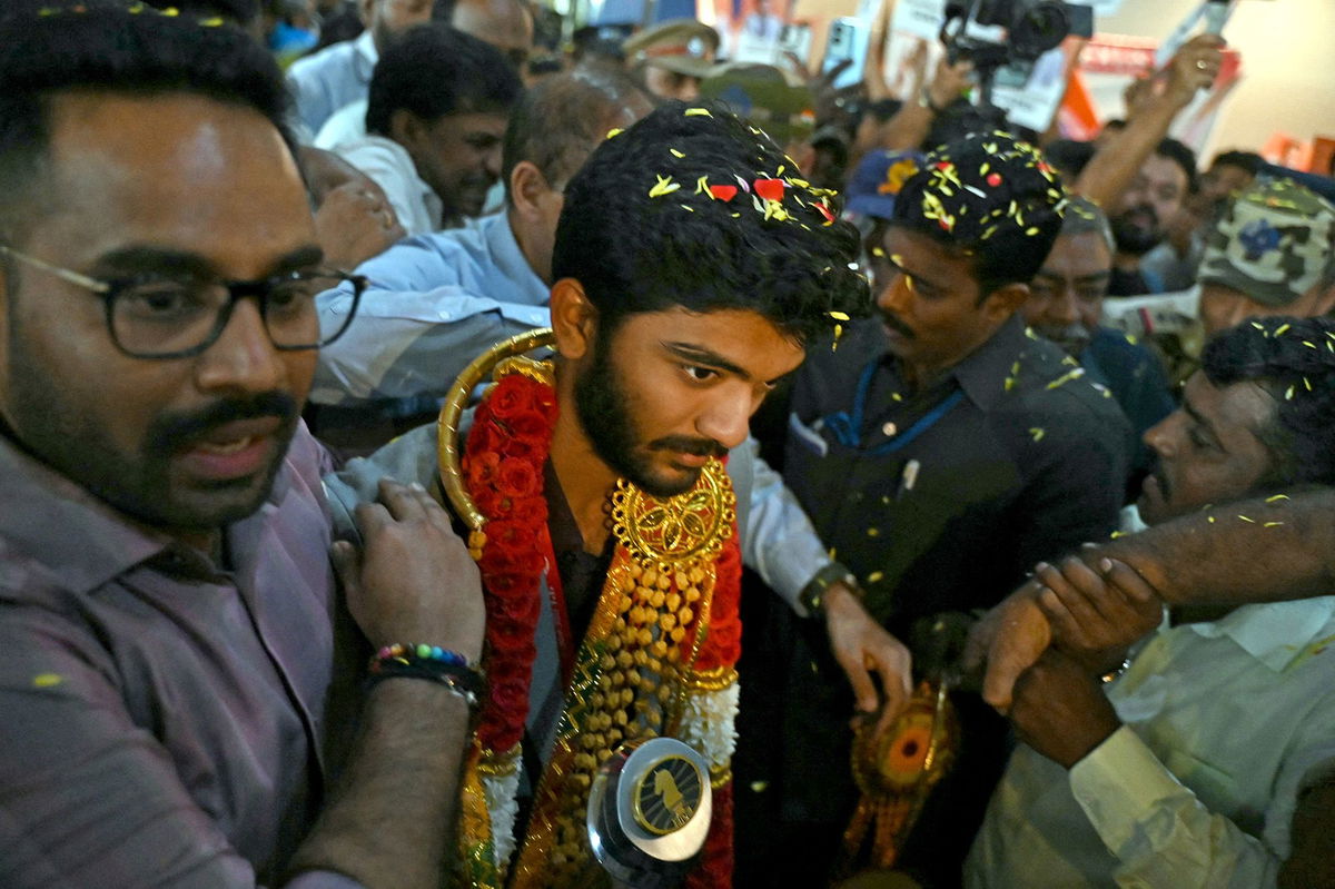 <i>R. Satish Babu/AFP/Getty Images via CNN Newsource</i><br/>Gukesh Dommaraju is welcomed home upon his arrival at the Chennai International Airport on December 16 after his win at the FIDE World Chess Championship in Singapore.