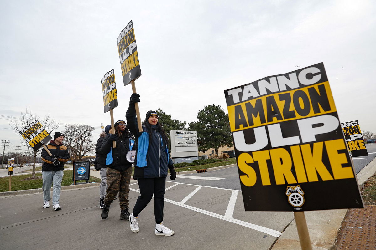 <i>Daniel Cole/Reuters via CNN Newsource</i><br/>Striking workers picket outside an Amazon warehouse in City of Industry