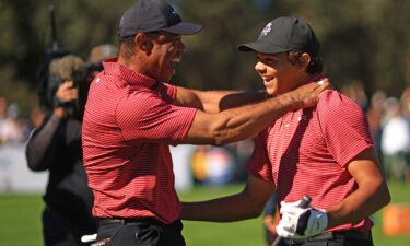 Tiger Woods and his son Charlie Woods celebrate after Charlie hit a hole-in-one at the PNC Championship.