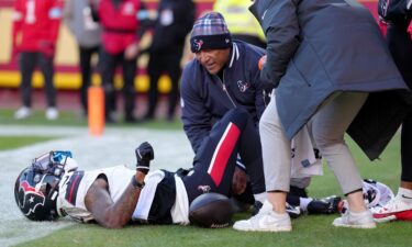 Medical staff look at Houston Texans wide receiver Tank Dell after he suffered multiple knee injuries while catching a touchdown in the third quarter of Saturday's game against the Kansas City Chiefs.