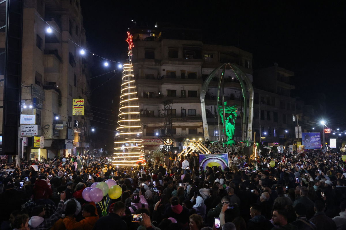 <i>Anwar Amro/AFP/Getty Images via CNN Newsource</i><br/>People attend a Christmas tree lighting in the Druze-majority area of Jaramana