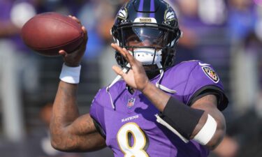 Baltimore Ravens quarterback Lamar Jackson warms up prior to the game against the Washington Commanders at M&T Bank Stadium on October 13.