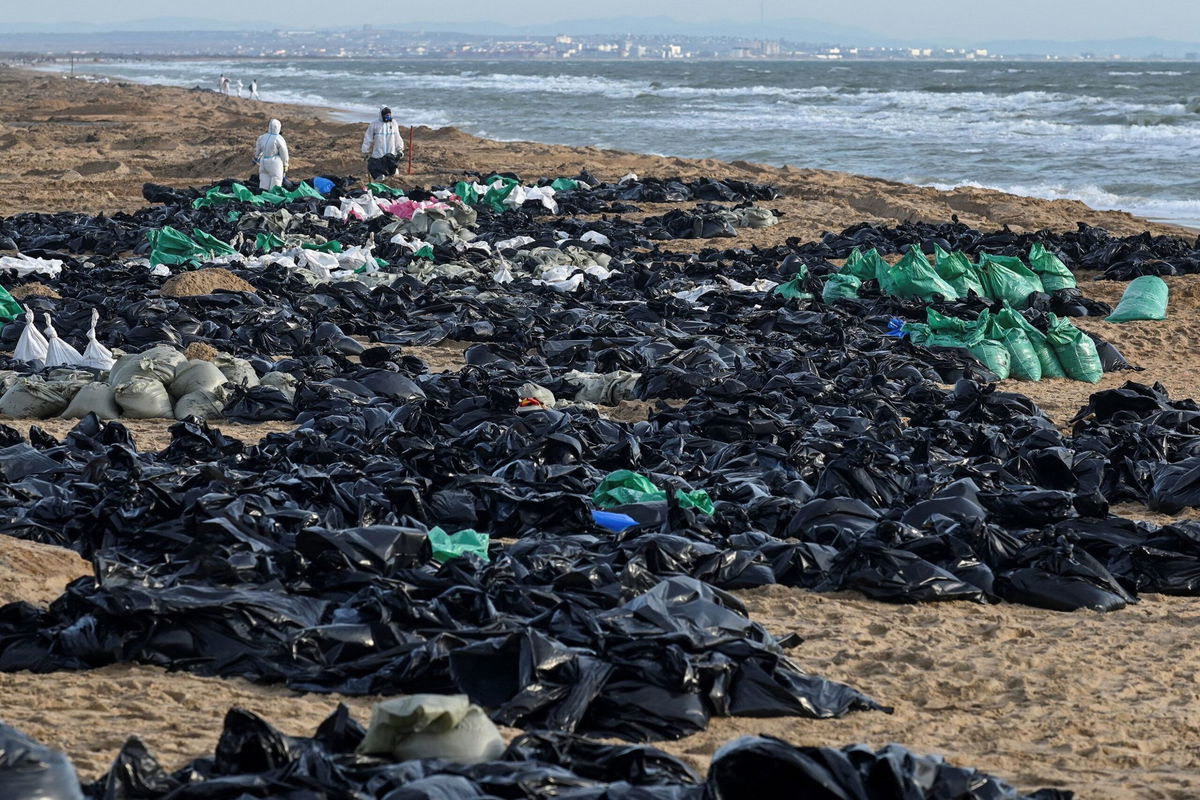 <i>Sergey Pivovarov/Reuters via CNN Newsource</i><br/>Volunteers work to clear spilled oil on the Russian coastline in the Kerch Strait