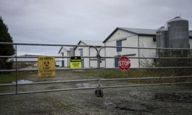 Biosecurity warning signs are seen on a locked gate at a commercial poultry farm in Abbotsford