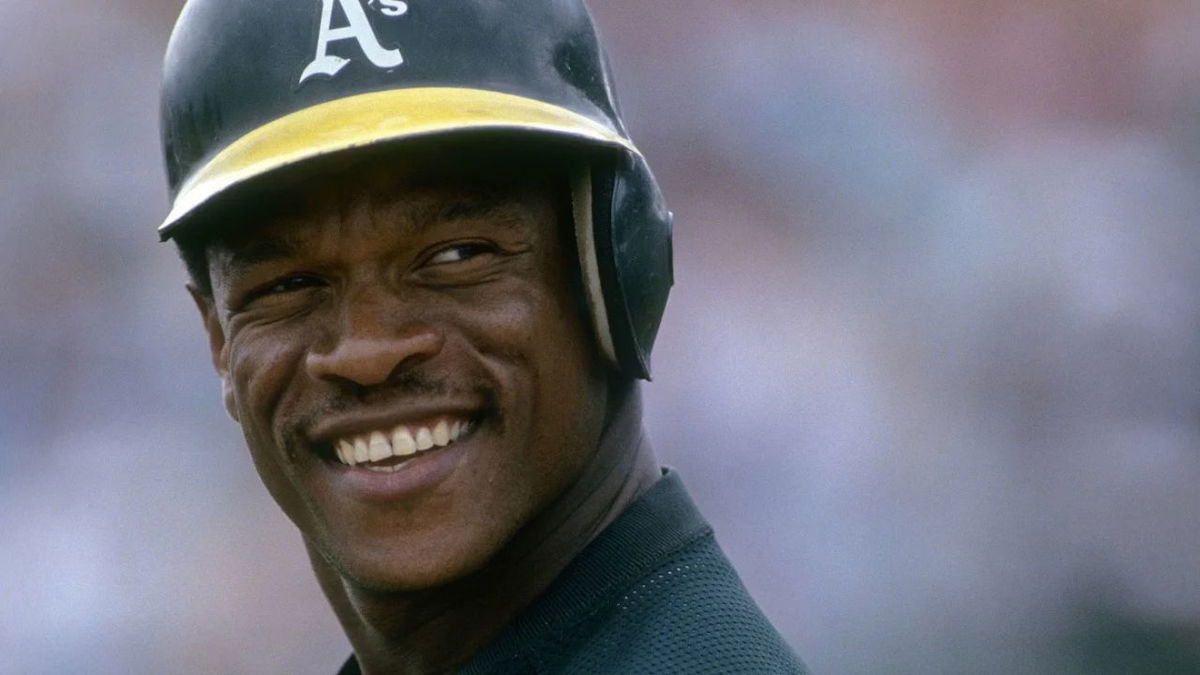 Outfielder Rickey Henderson of the Oakland Athletics on the field smiling during a game at the Oakland Coliseum in Oakland, California. Focus on Sport/Getty Images