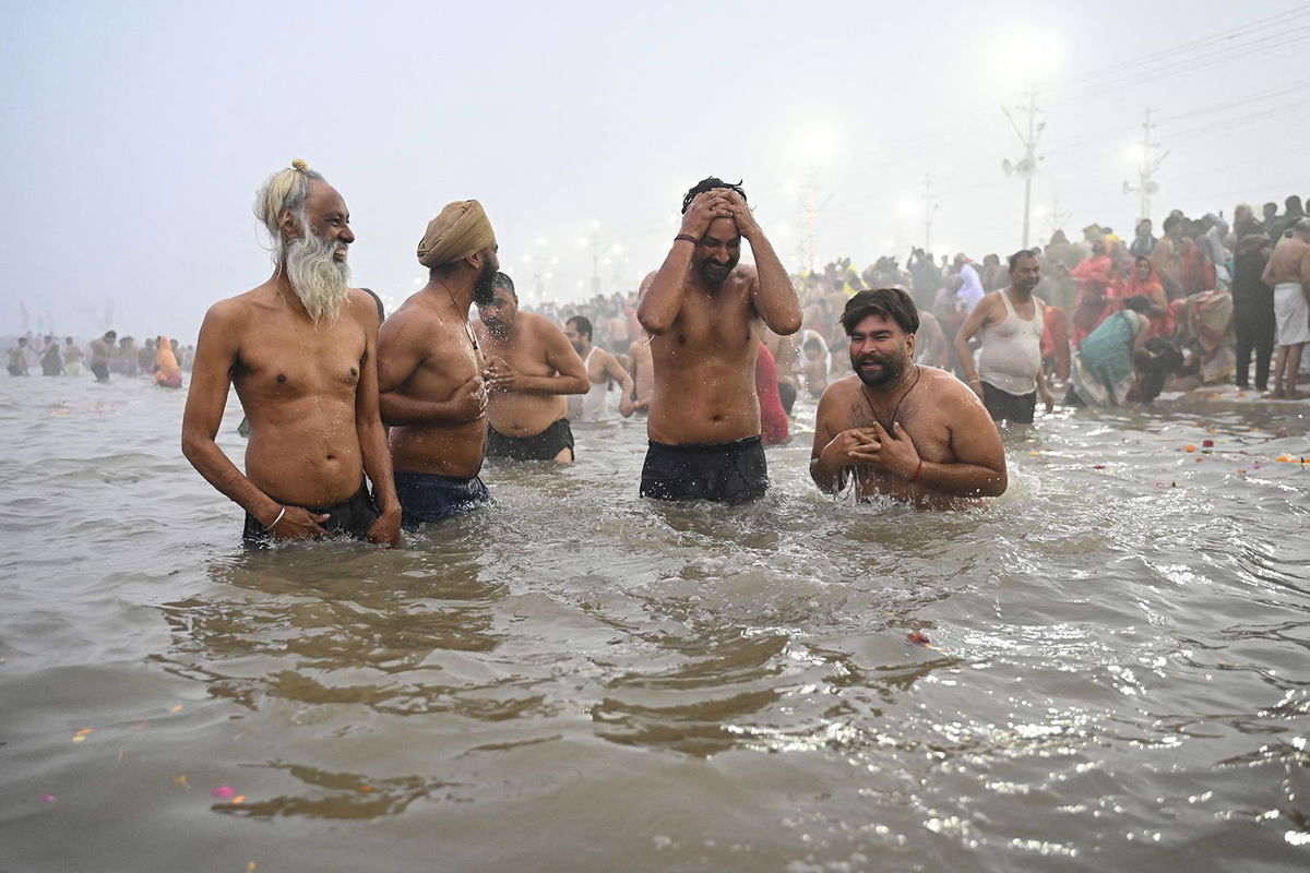 <i>R. Satish Babu/AFP/Getty Images via CNN Newsource</i><br/>Hindu pilgrims take a dip in the sacred waters of Sangam