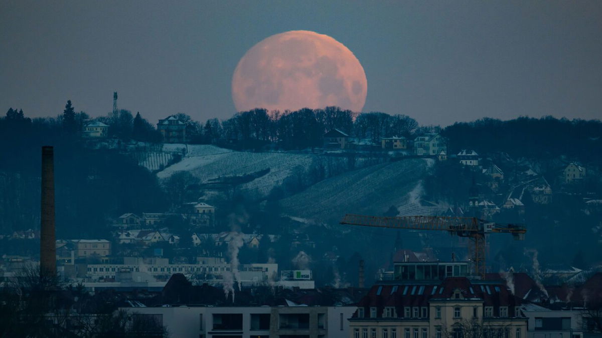 <i>Michael Probst/AP via CNN Newsource</i><br/>The moon sets over fog that drifts over the Taurus region near Frankfurt