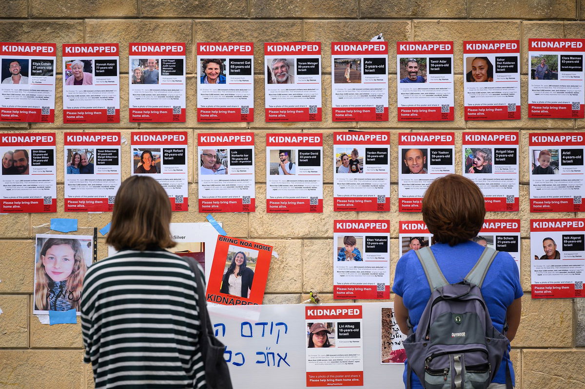 <i>Leon Neal/Getty Images via CNN Newsource</i><br/>Photographs of some hostages taken by Hamas are seen here in Tel Aviv