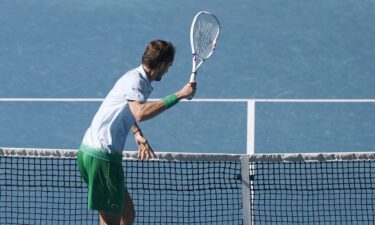 Daniil Medvedev takes aim at a small camera attached to the net after growing frustrated.