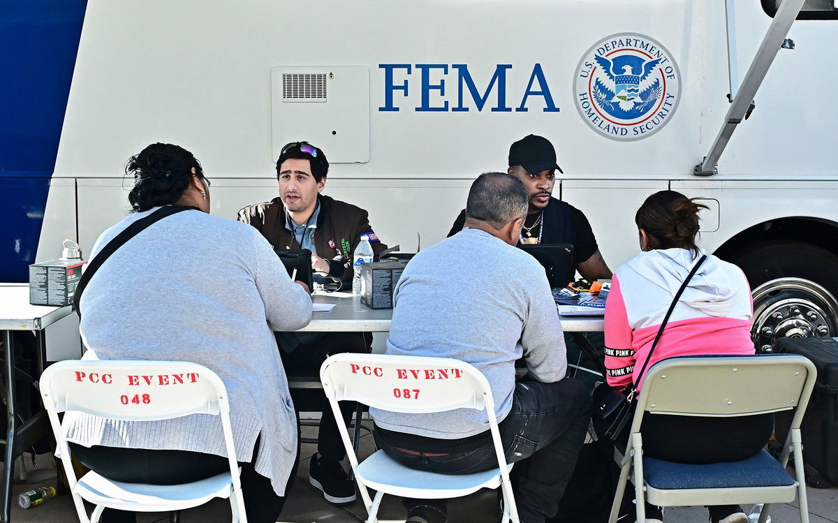 <i>Frederic J. Brown/AFP/Getty Images via CNN Newsource</i><br/>Fire-affected residents meet with FEMA officials on January 14 in Pasadena