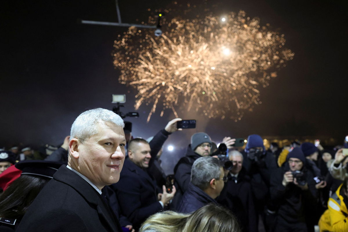 <i>George Calin/Inquam Photos/Reuters via CNN Newsource</i><br/>Romanian minister of Internal Affairs Catalin Predoiu amid fireworks as Romania and Bulgaria join the EU's Schengen area.