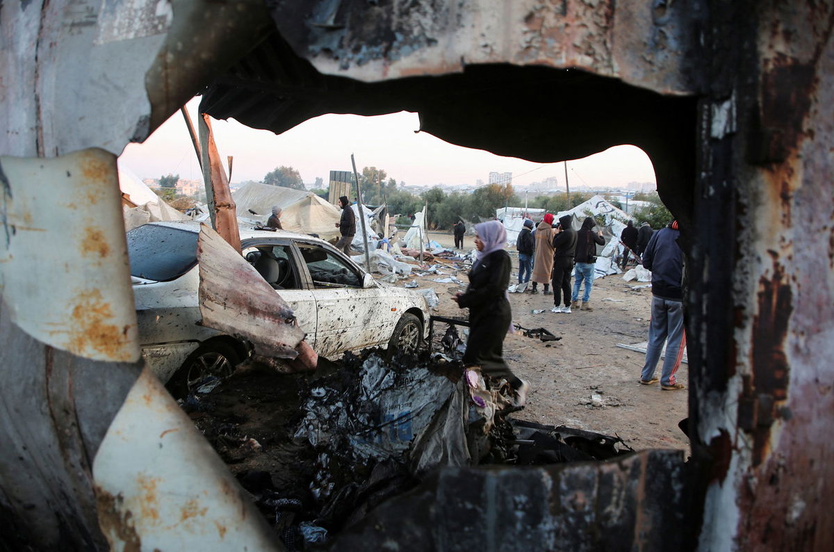 <i>Hatem Khaled/Reuters via CNN Newsource</i><br />Palestinians survey the aftermath of an Israeli strike in Al-Mawasi