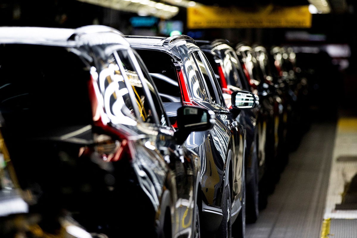 <i>Richard A. Brooks/AFP/Getty Images via CNN Newsource</i><br/>A worker checking a car on a Nissan production line.