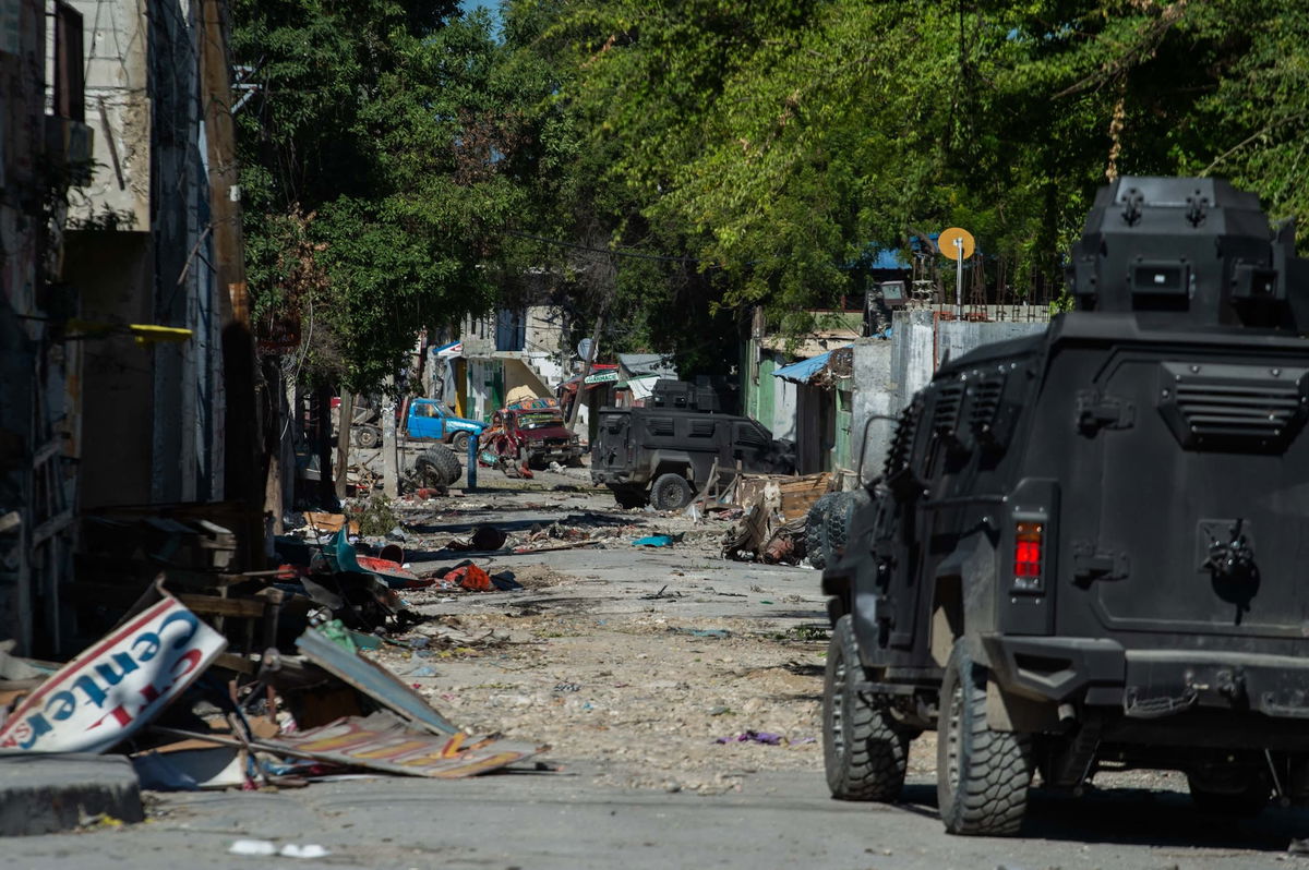 <i>Clarens Siffroy/AFP/Getty Images via CNN Newsource</i><br/>Police patrol around Bernard Mevs hospital where armed gangs have spread violence in Port-au-Prince on December 17