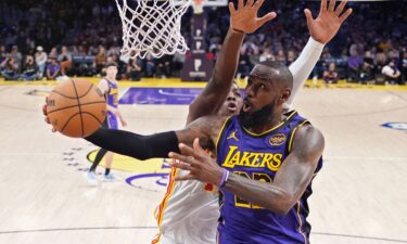 LeBron James scoring on a jumper over De'Andre Hunter and Bogdan Bogdanovic of the Atlanta Hawks. James set another record on Friday as he surpassed the legendary Michael Jordan’s mark for the most 30-point games in NBA history.