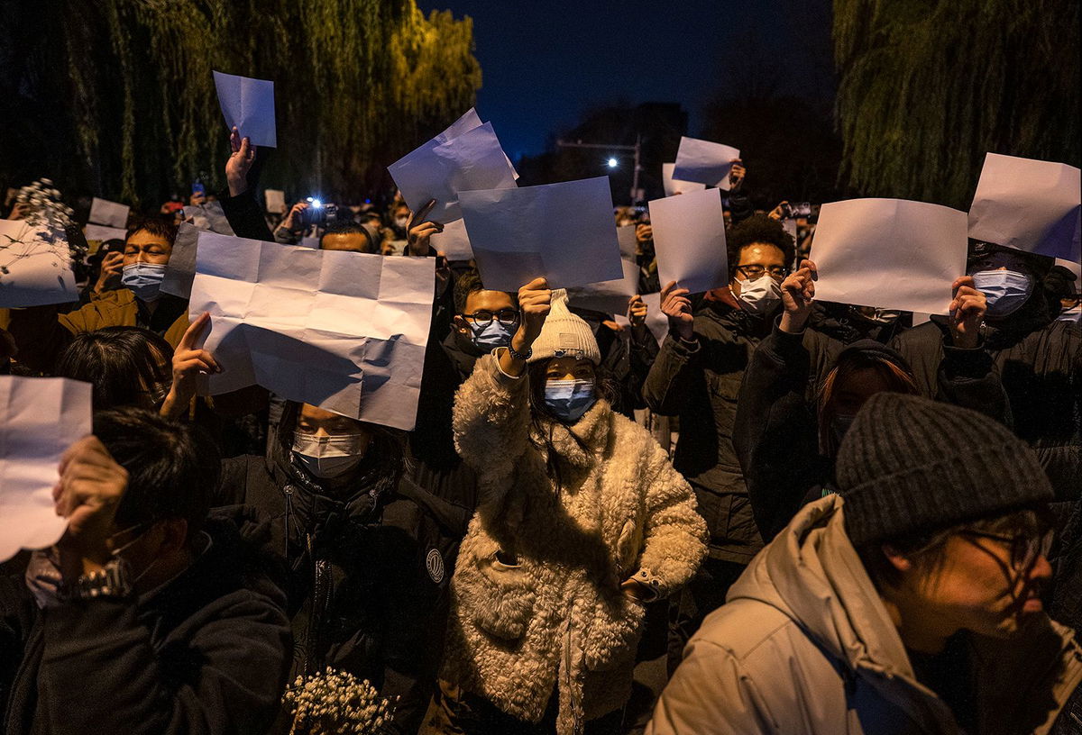 <i>Kevin Frayer/Getty Images via CNN Newsource</i><br/>Protesters hold up pieces of white paper to symbolize censorship during a protest against China's strict zero Covid measures in Beijing