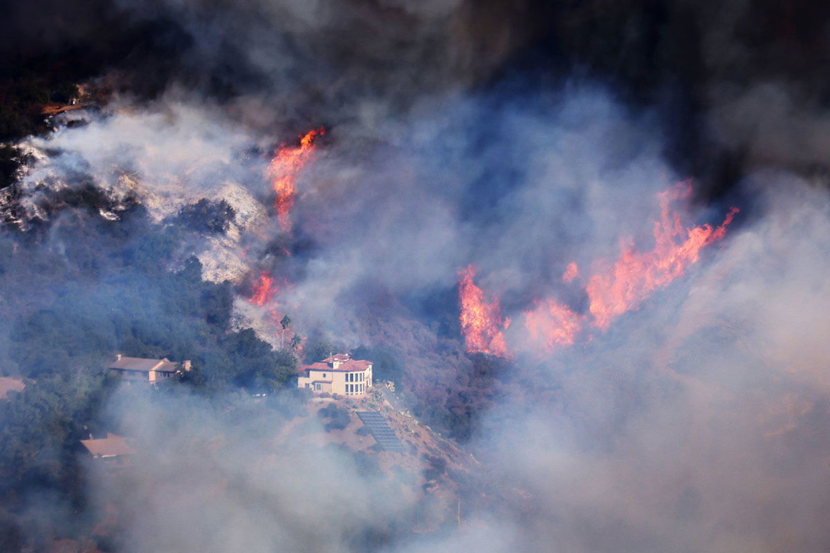 <i>David Swanson/AFP/Getty Images via CNN Newsource</i><br />A house is threatened as the Palisades Fire grows in the mountains in the community of Topanga