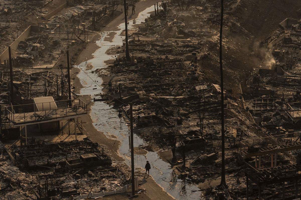 <i>Jae C. Hong/AP via CNN Newsource</i><br />A person walks amid the destruction left behind by the Palisades Fire in Los Angeles on January 9.