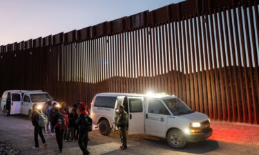 Migrants turn themselves in to US Customs and Border Patrol officers after crossing over a section of border wall into the US on January 5 in Ruby