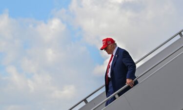 President Donald Trump steps off Air Force One after landing at the Palm Beach International Airport in West Palm Beach