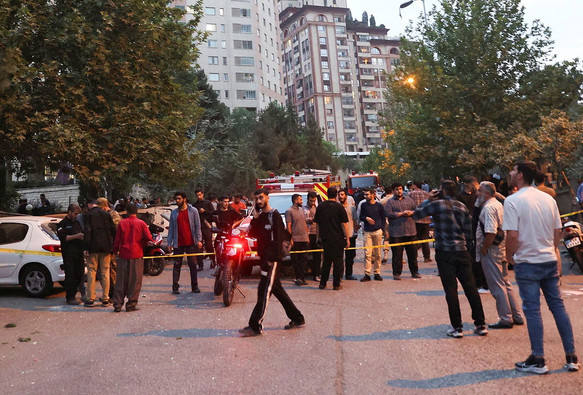 <i>Majid Asgaripour/Wana News Agency/Reuters via CNN Newsource</i><br/>People gather in the street in the aftermath of Israeli strikes